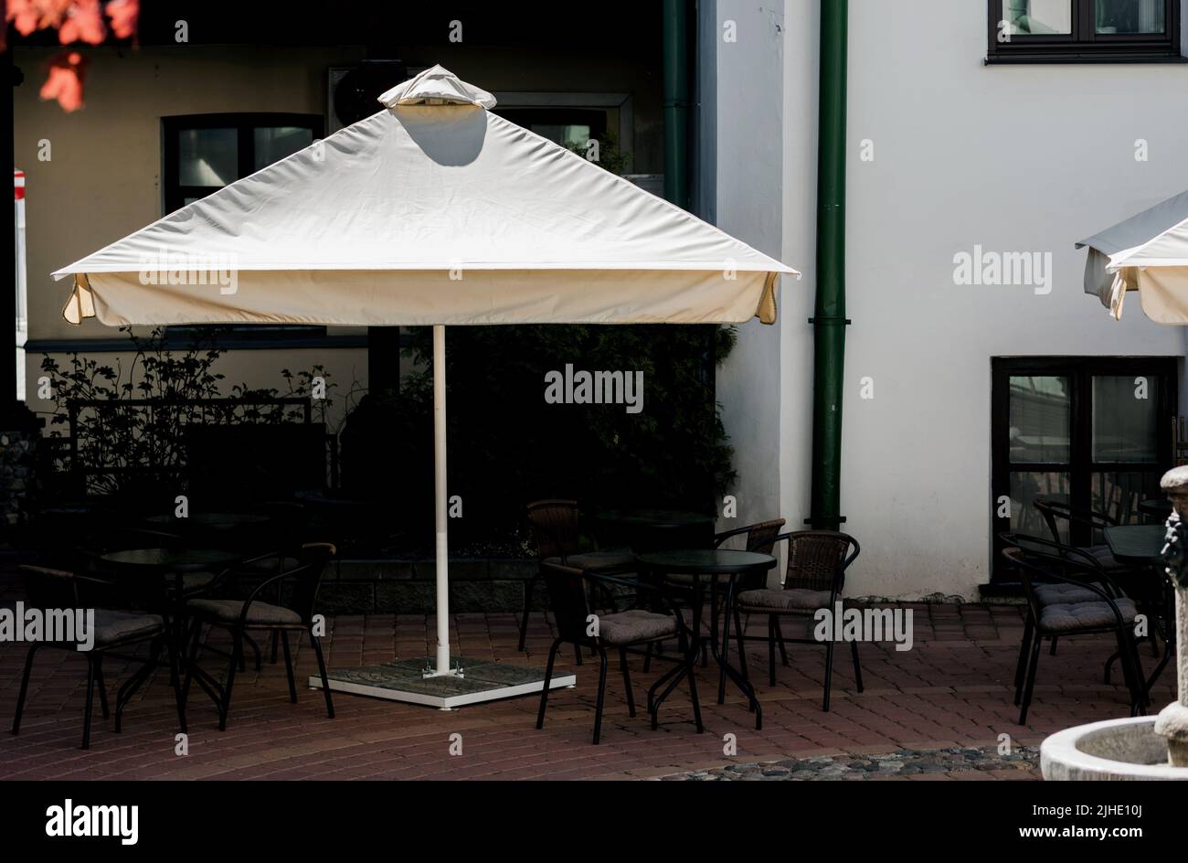 Street Restaurant In Modern Building Outdoor Seat Parasol Stock Photo street-restaurant-in-modern-building-outdoor-seat-parasol-stock-photo