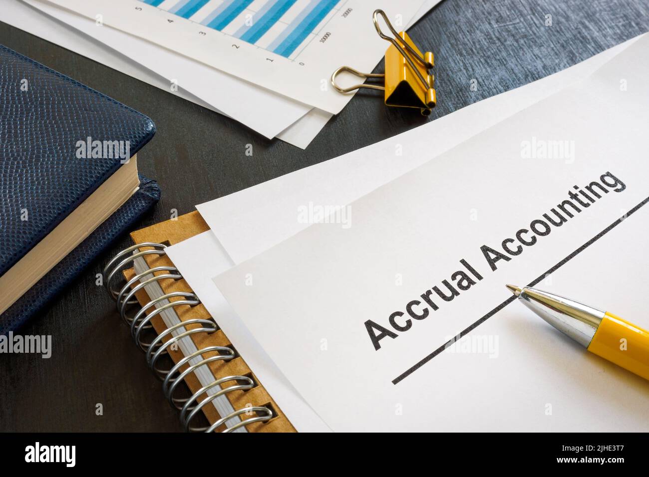 Documents about accrual accounting near notepad and pen. Stock Photo