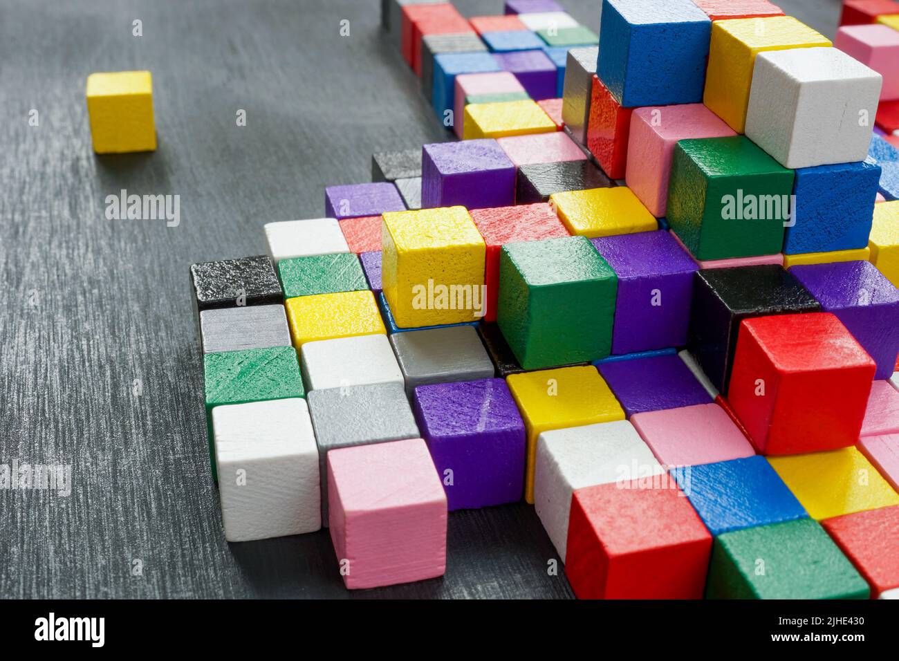 Lots of colorful cubes on the dark surface. Variety abstract concept. Stock Photo
