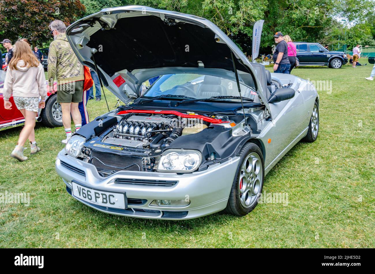Front view of a 1999 Alfa Romeo Spider sports car in silver with it's bonnet up at The Berkshire Motor Show in Reading, UK Stock Photo