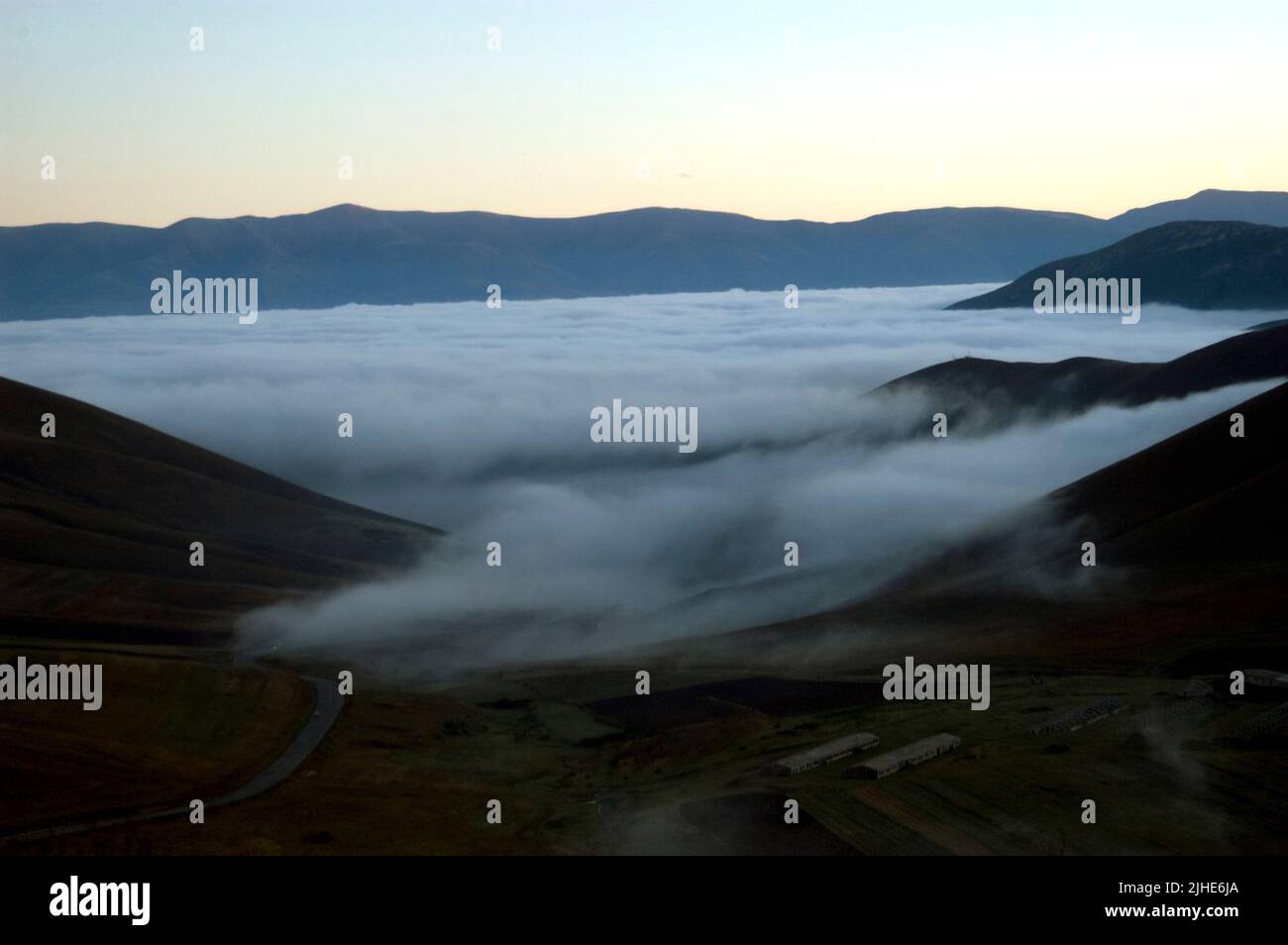 A scenic view of Aragats mount surrounded by fog Stock Photo