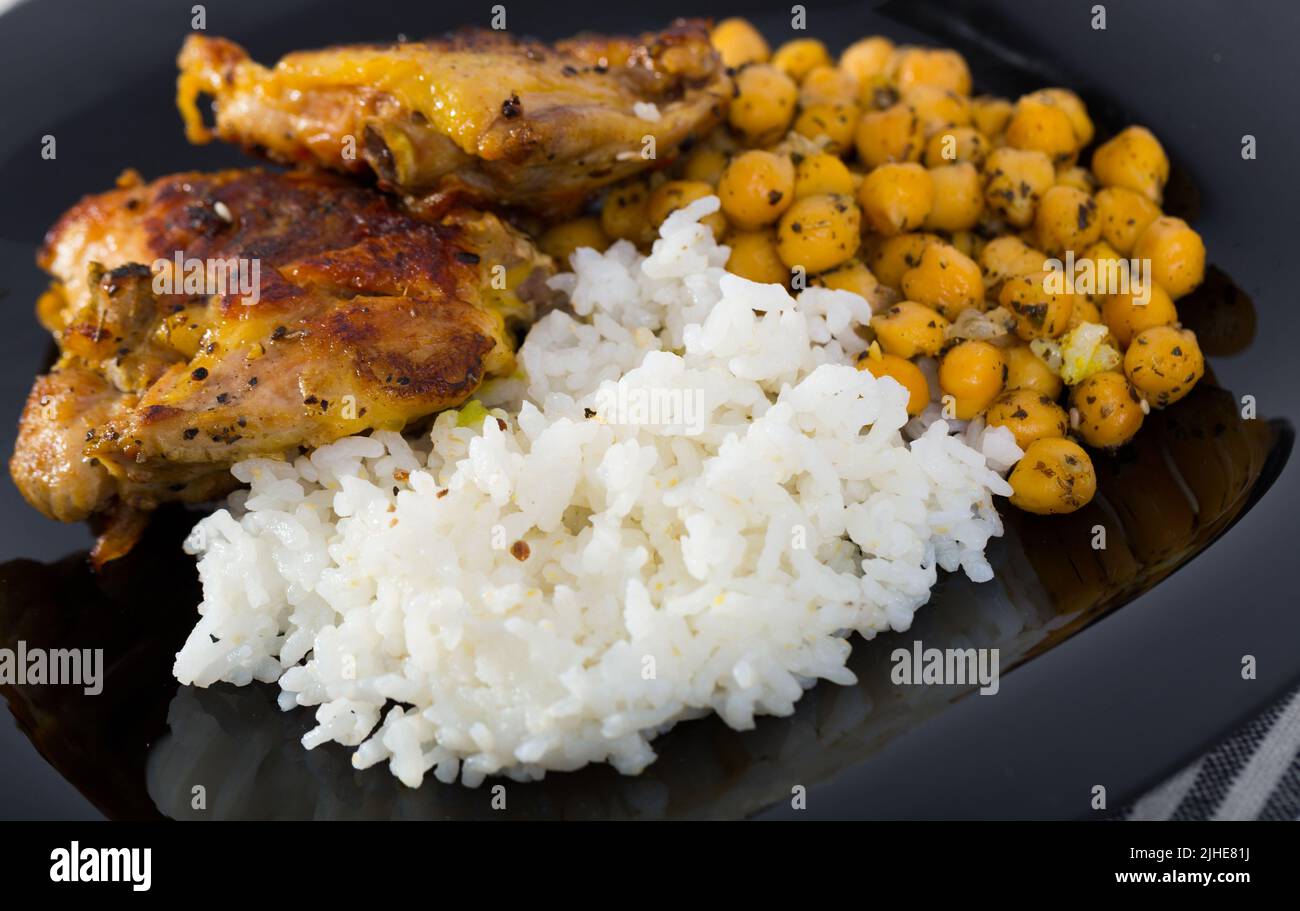 Baked chicken thighs with rice Stock Photo - Alamy