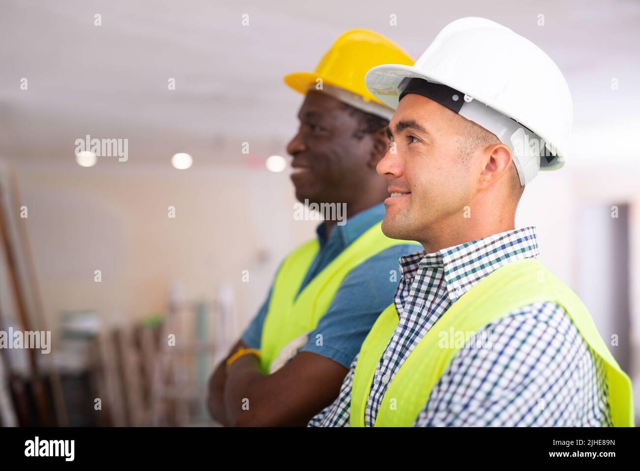 Positive engineers inspecting construction site Stock Photo