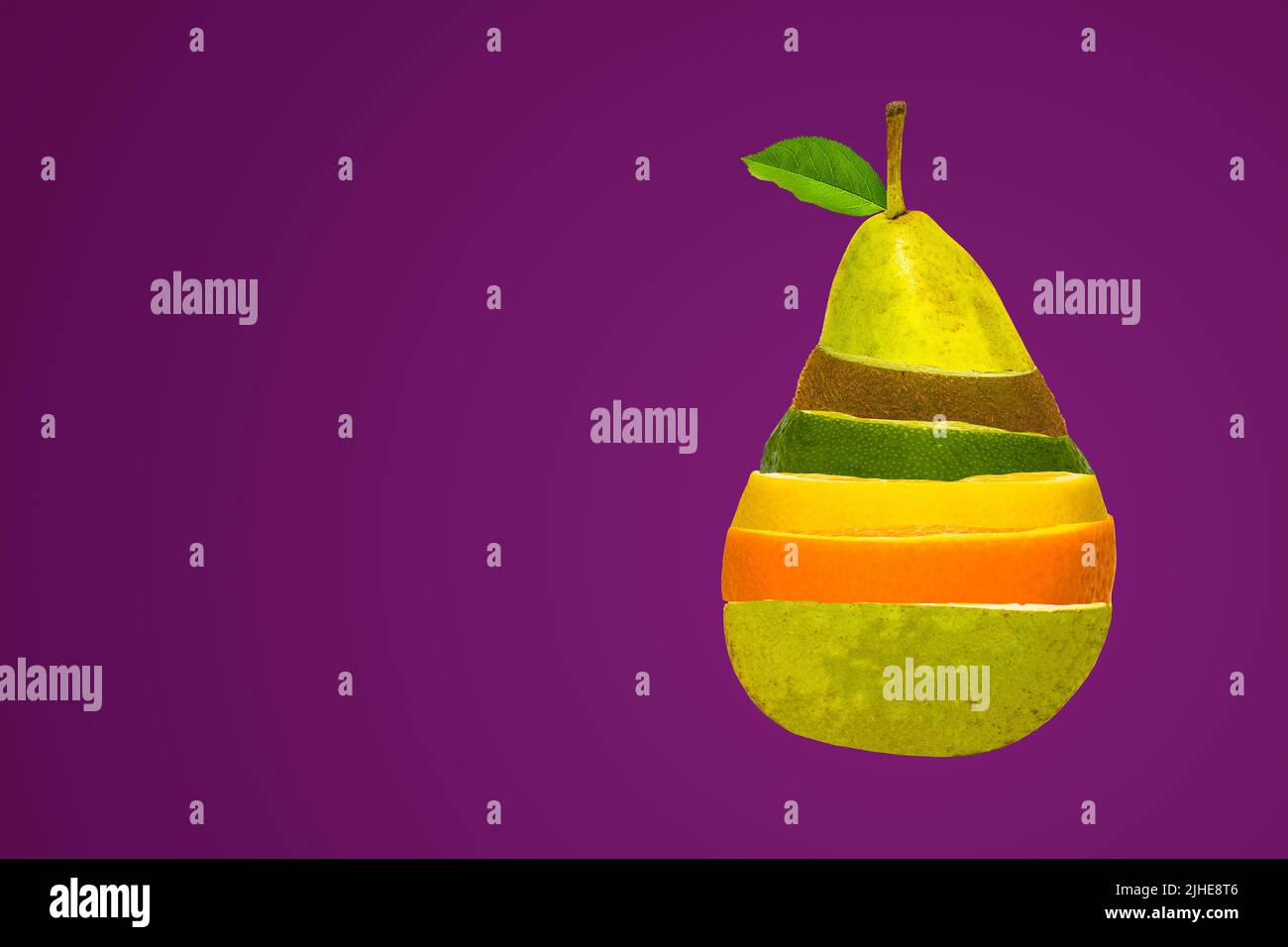 concept image of mixed fruit salad in a pear shape shaped mix of pear kiwi orange lemon lime on a colorful colourful purple background Stock Photo