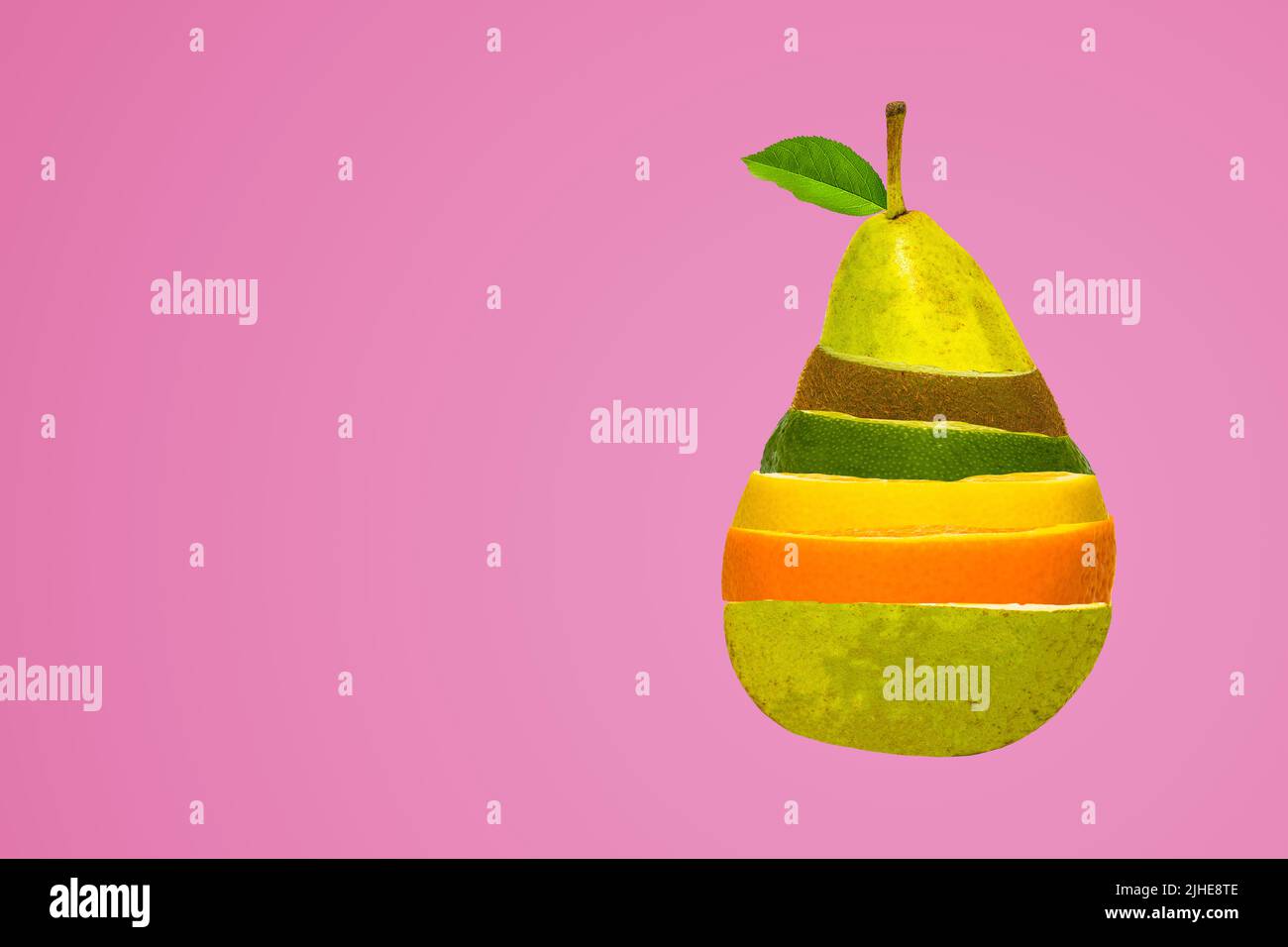 concept image of mixed fruit salad in a pear shape shaped mix of pear kiwi orange lemon lime on a colorful colourful pink background Stock Photo