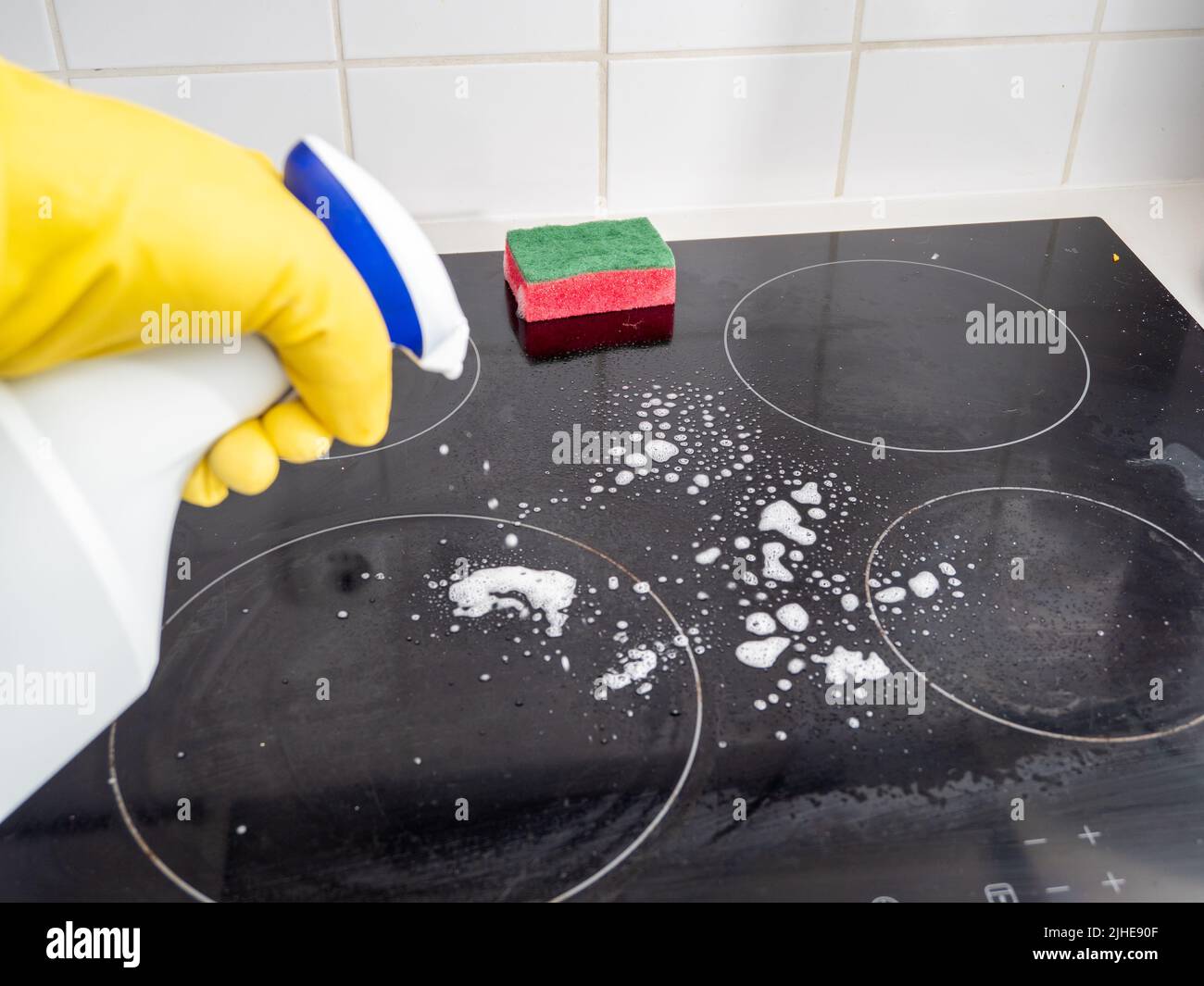 Washes the electric stove. Kitchen cleaning. Dirty electric stove Stock