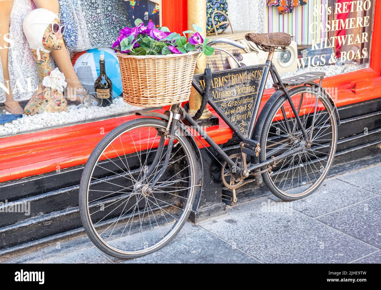 Edinburgh, Scotland, UK – June 20 2022. Close up of a vintage bicycle used to advertise W Armstrong and Son vintage clothing shop in Edinburgh, Scotla Stock Photo