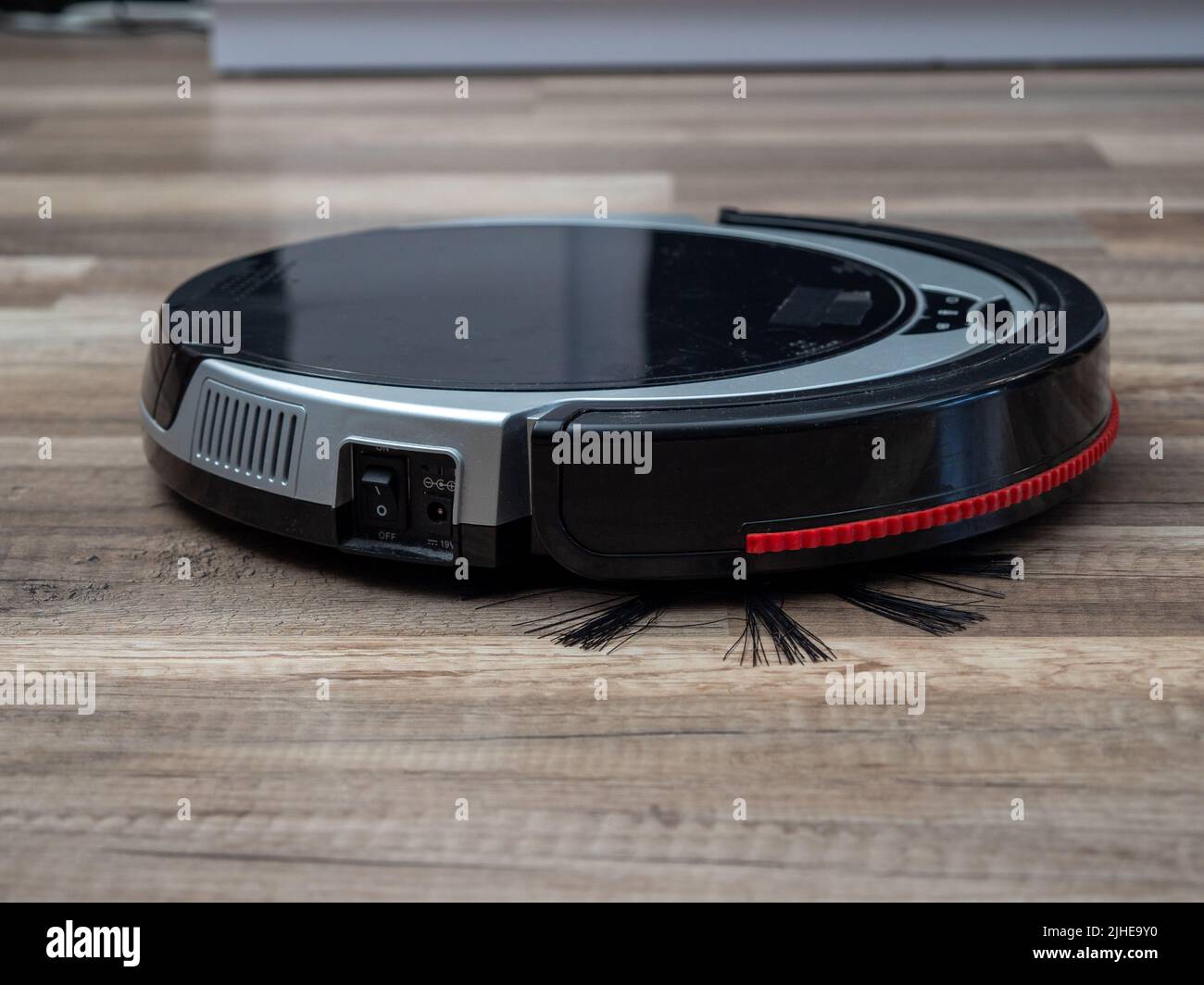 Robotic vacuum cleaner on a laminated wooden floor. Robot vacuum