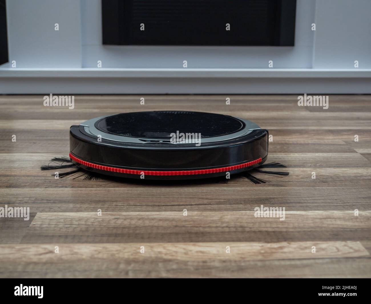 Robotic vacuum cleaner on a laminated wooden floor. Robot vacuum