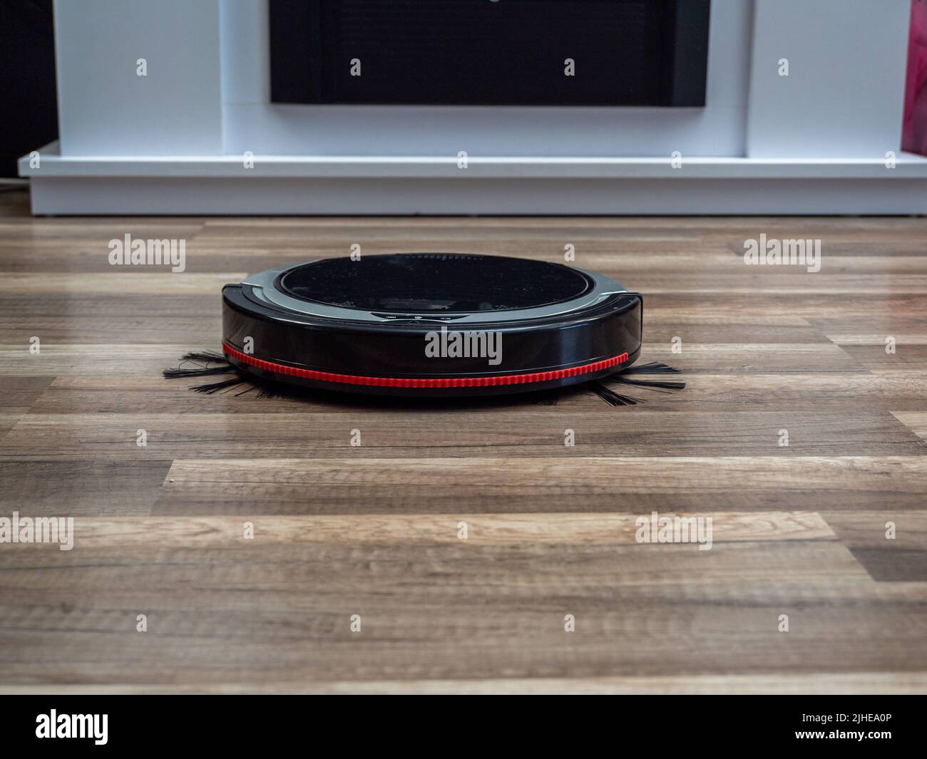 Robotic vacuum cleaner on a laminated wooden floor. Robot vacuum