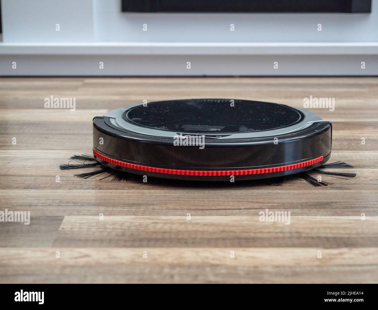 Robotic vacuum cleaner on a laminated wooden floor. Robot vacuum
