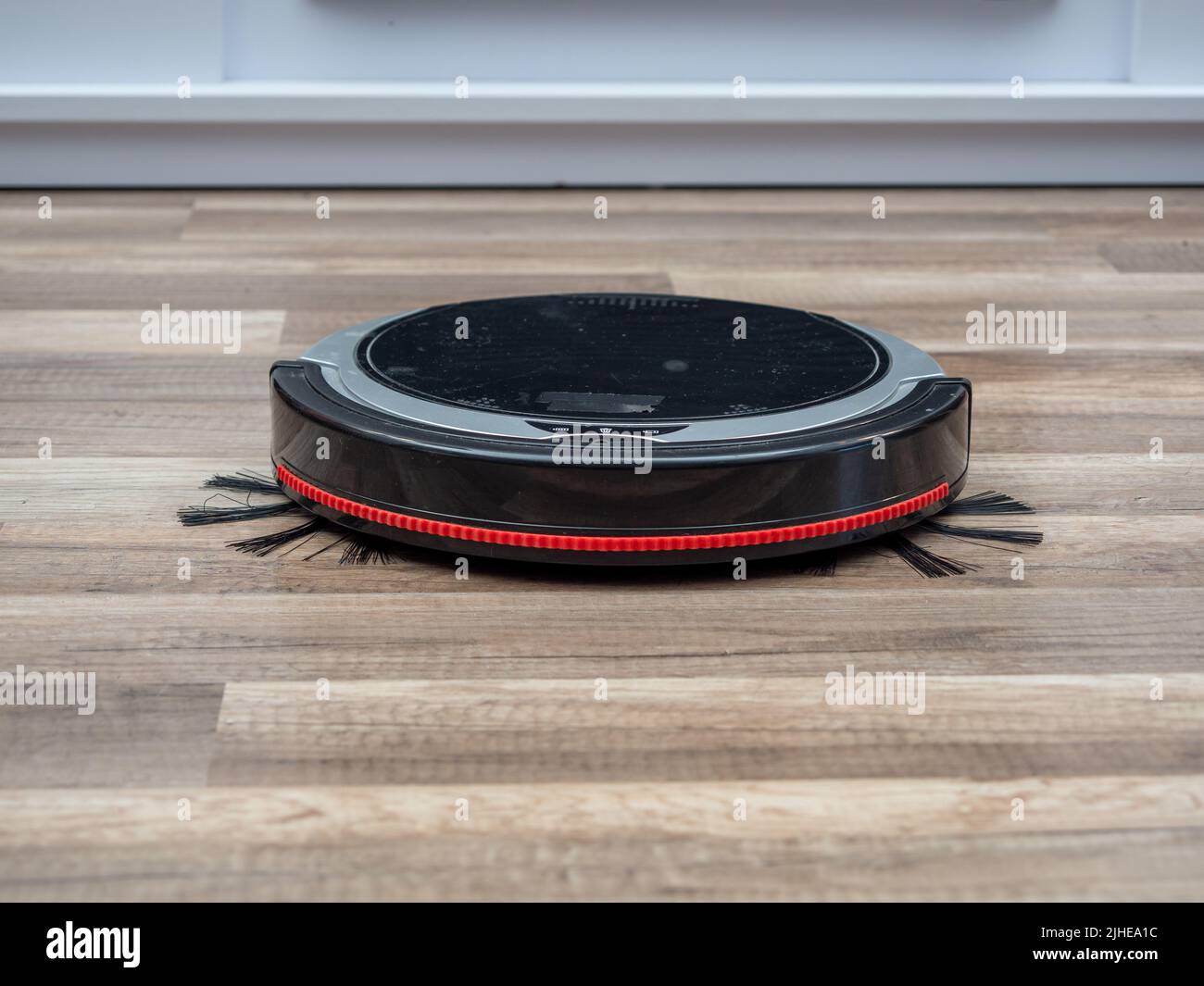 Robotic vacuum cleaner on a laminated wooden floor. Robot vacuum