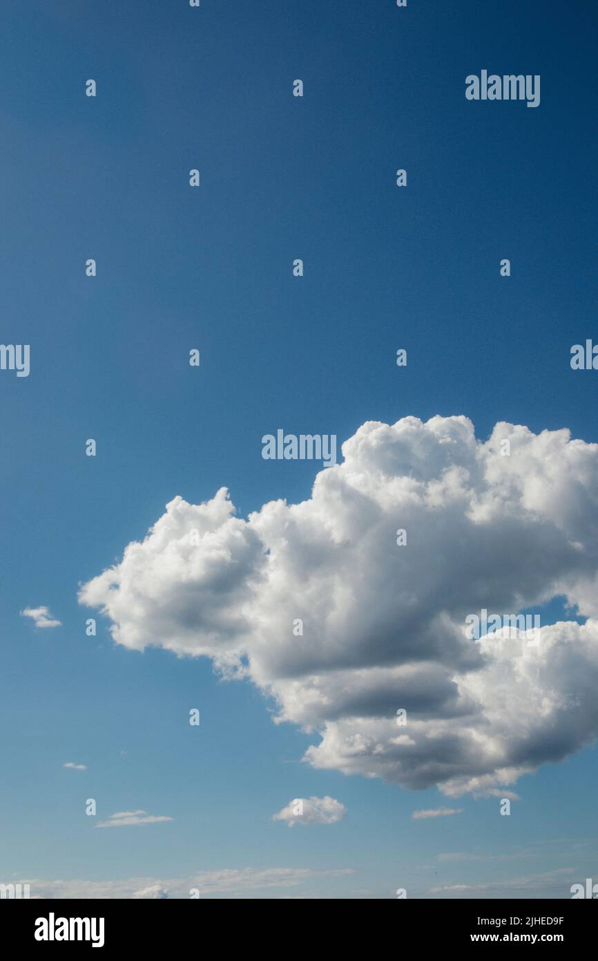 Fluffy white cumulus clouds against blue sky Stock Photo - Alamy