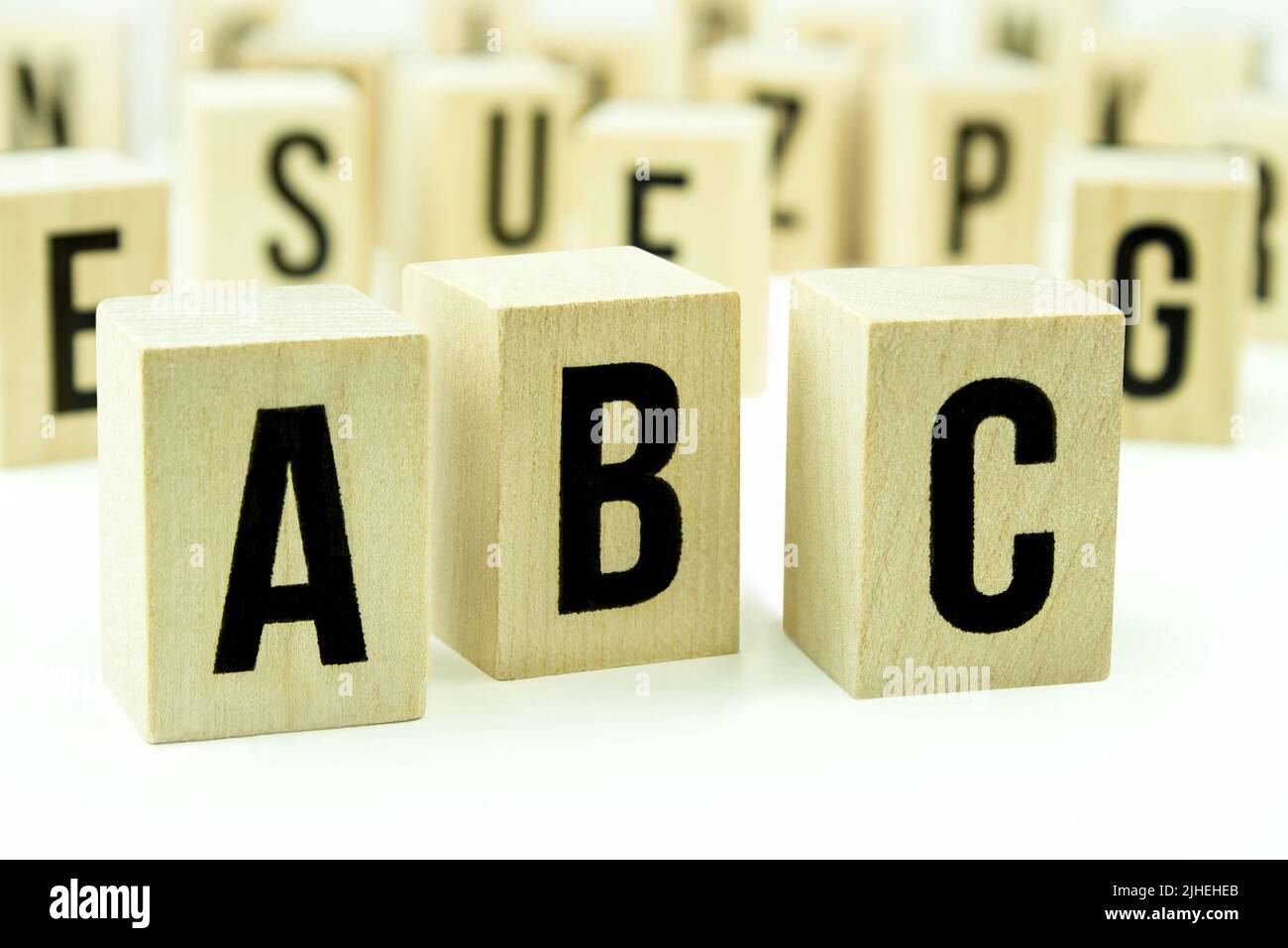 A B C letters on wooden cubes against white background Stock Photo