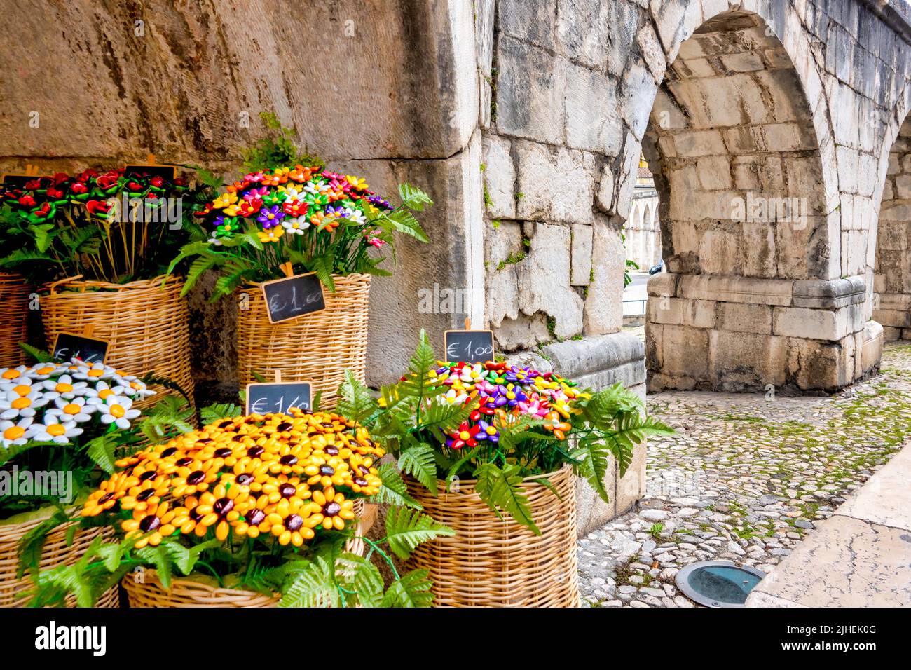 Confetti bouquet for sale under the arches of the Aqueduct Svevo, Sulmona, Italy Stock Photo