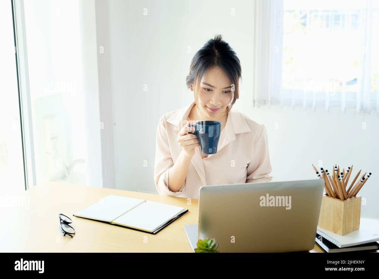 new normal, a businesswoman useing notebook and computer to work for a