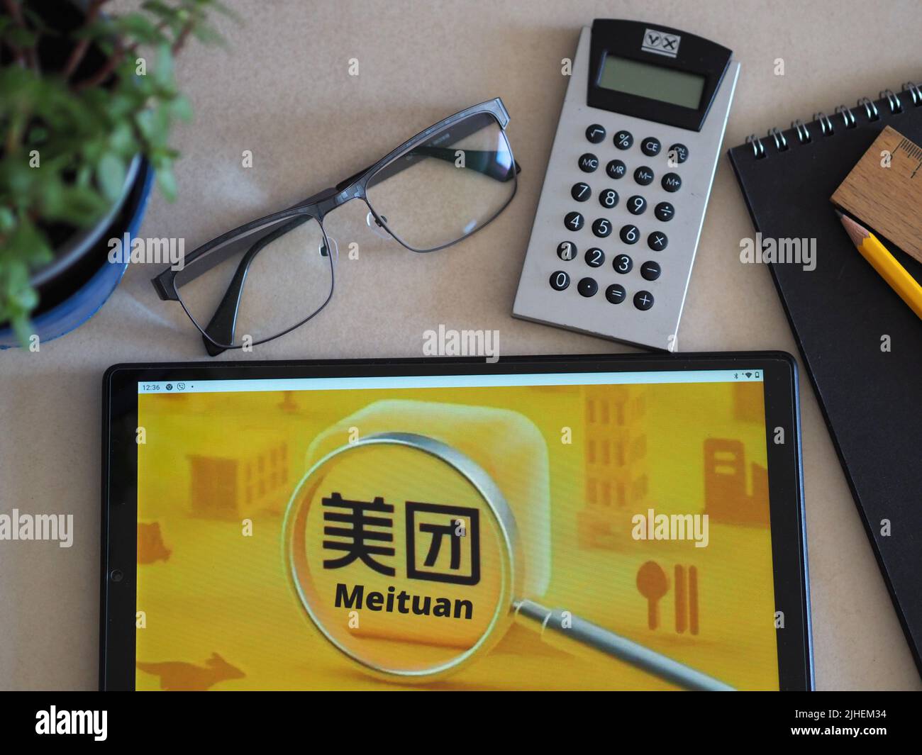 In this photo illustration, Meituan logo seen displayed on a tablet ...