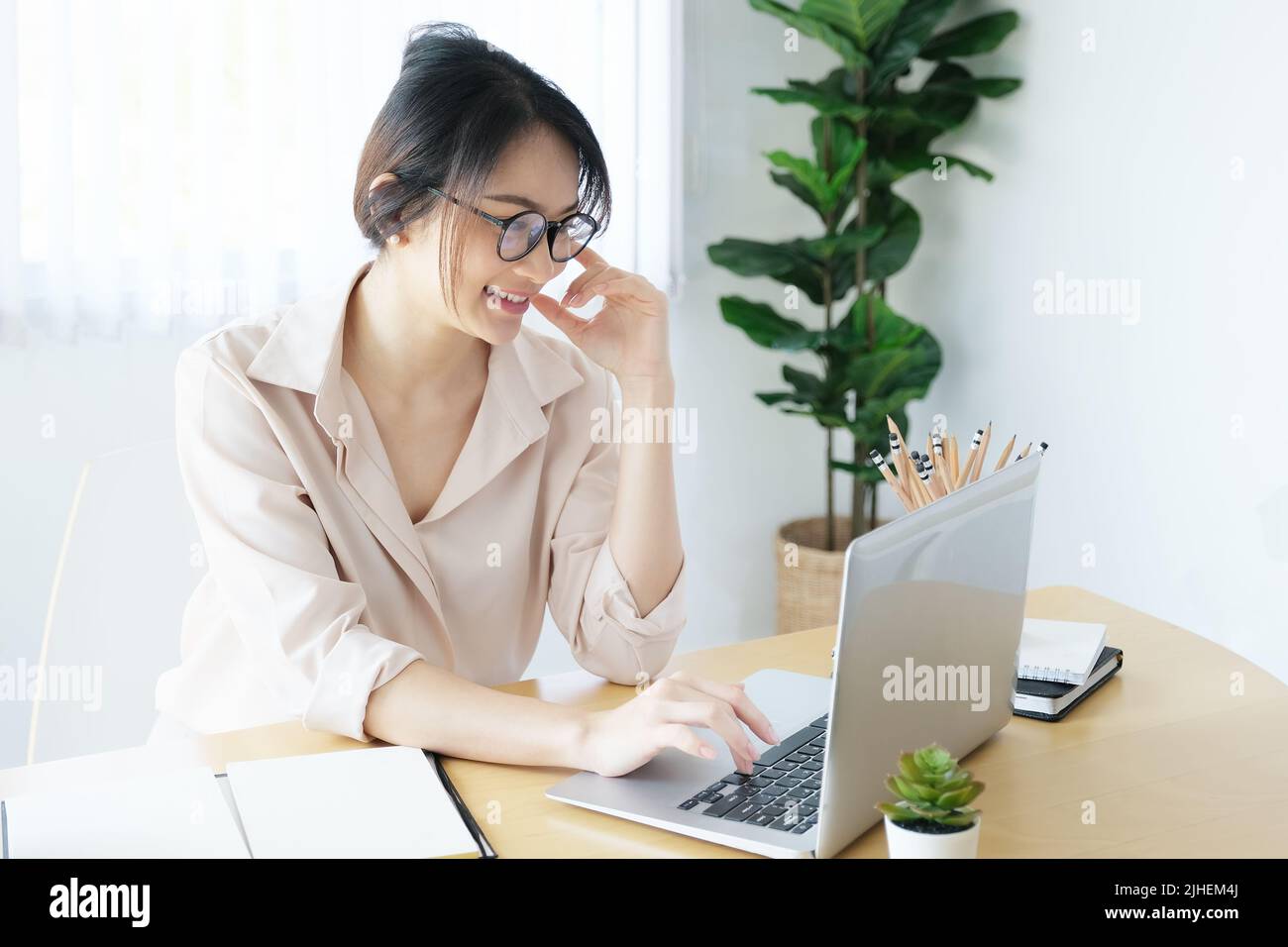 new normal, a businesswoman useing computer to work for a company Via the internet on your desk at home Stock Photo