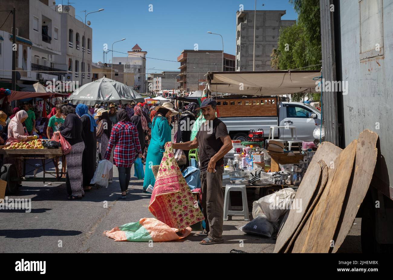 A man sells plastic table clothes at the Sunday Souk, a weekly market in Sousse, Tunisia. Stock Photo