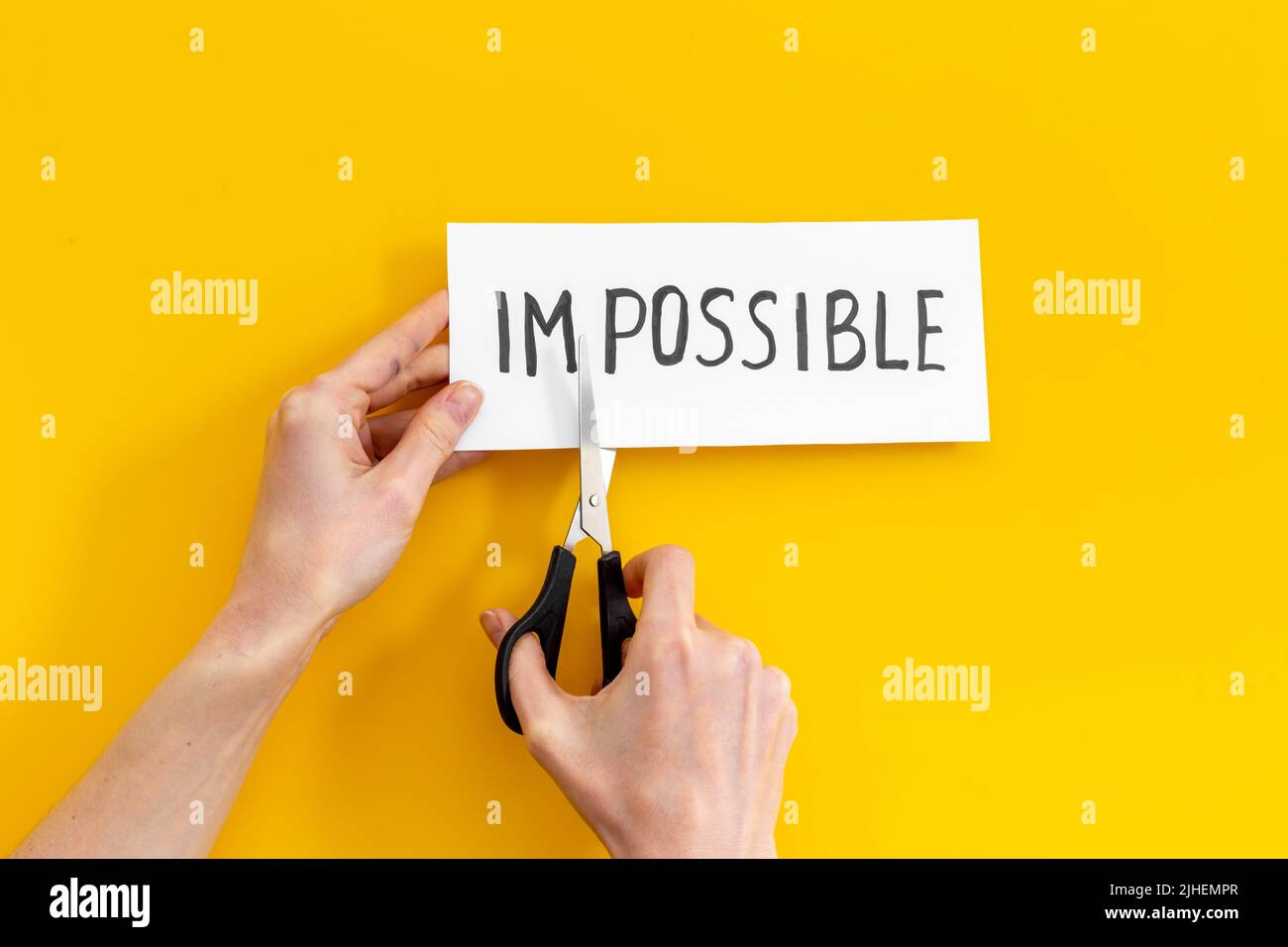 Hands changing word impossible to possible with scissors. Selfmade ...