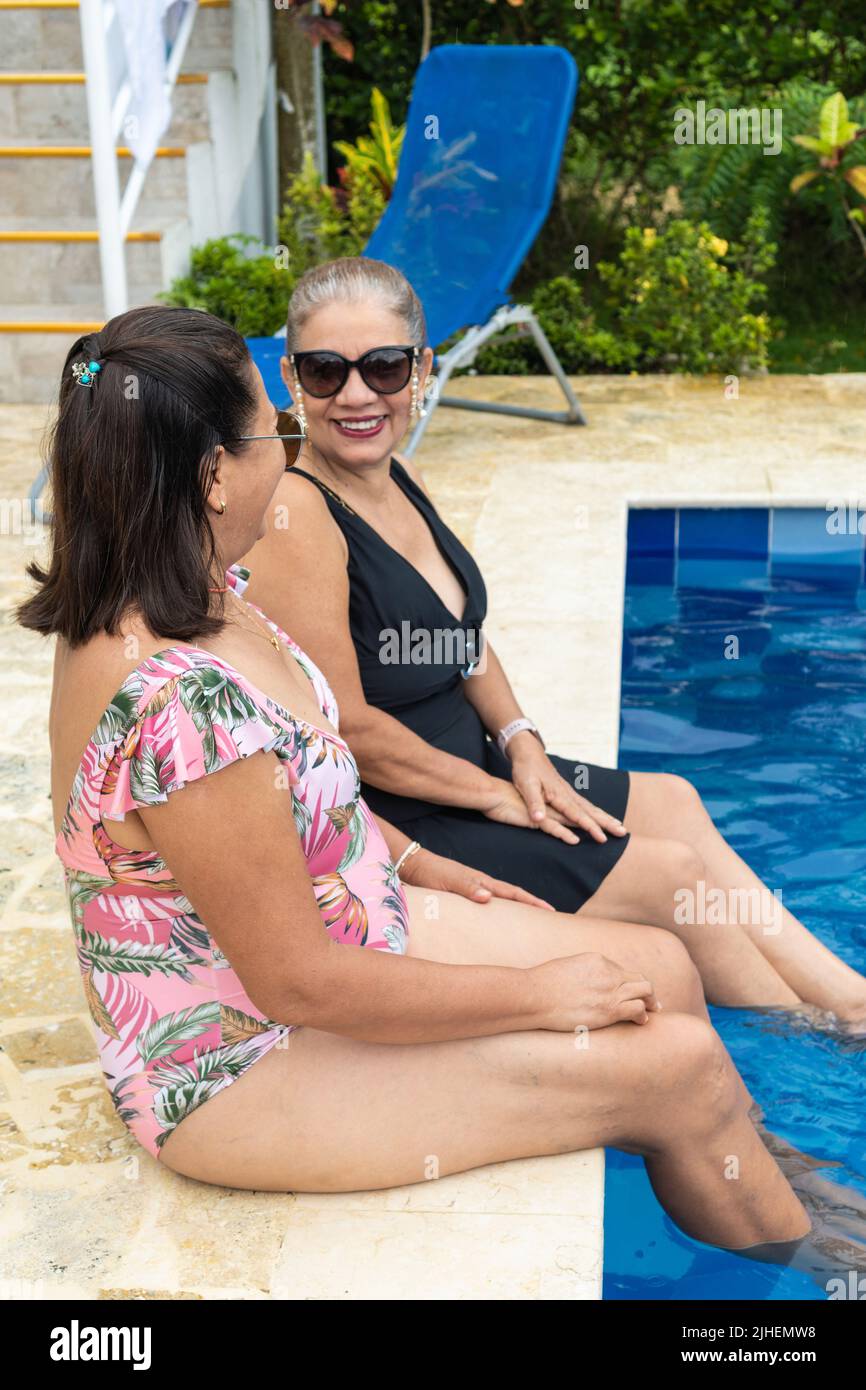 Two Older Women Having Fun At The Pool Stock Photo