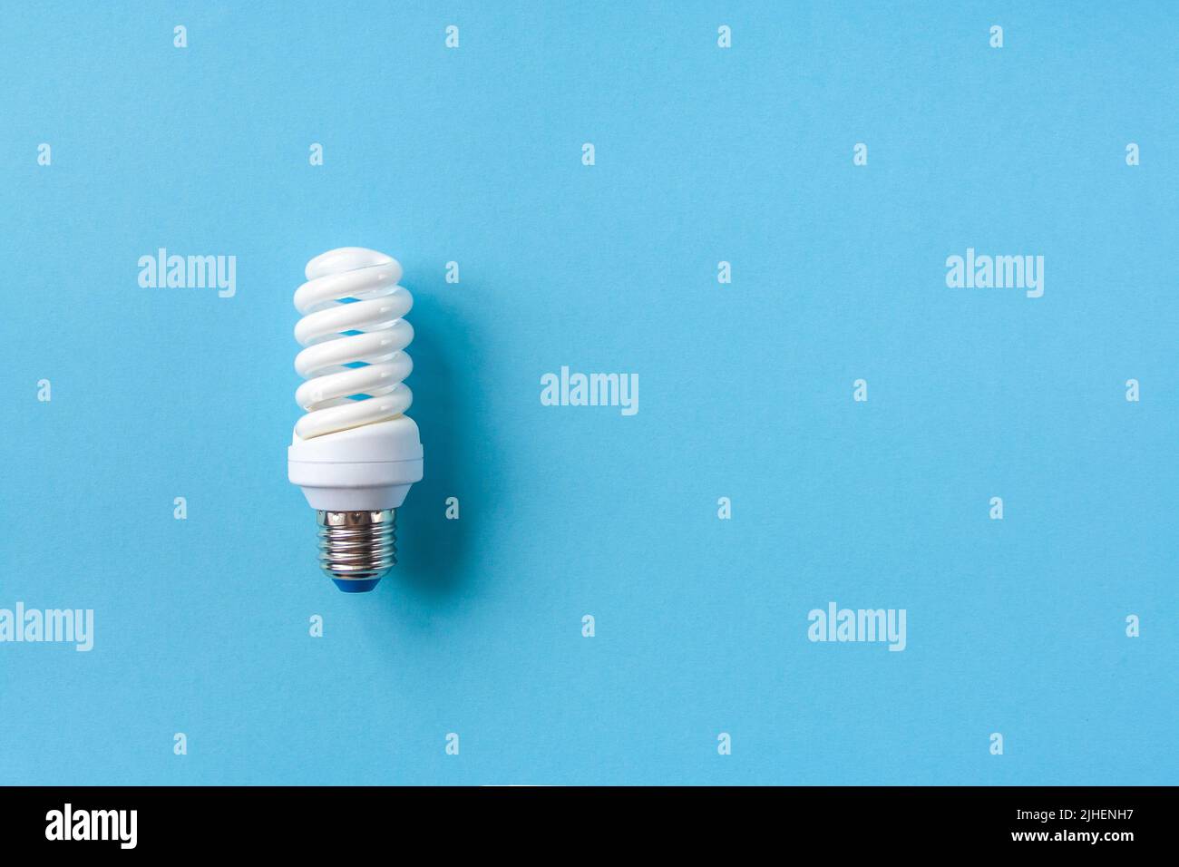 Energy saving light bulb on a blue background Stock Photo - Alamy