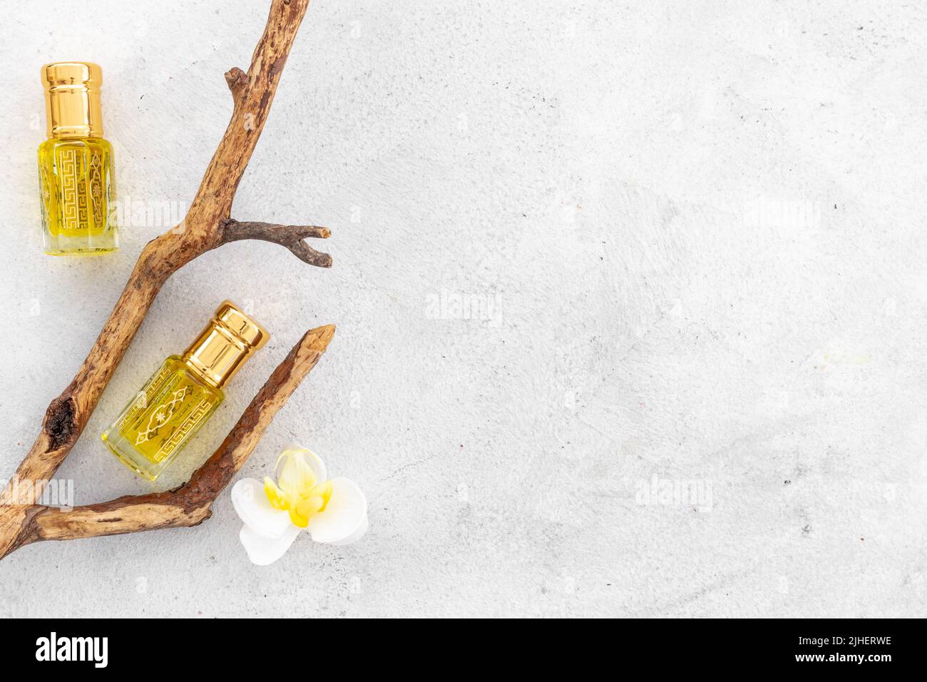 Arabian oud attar perfume essential oil in glass bottles, top view