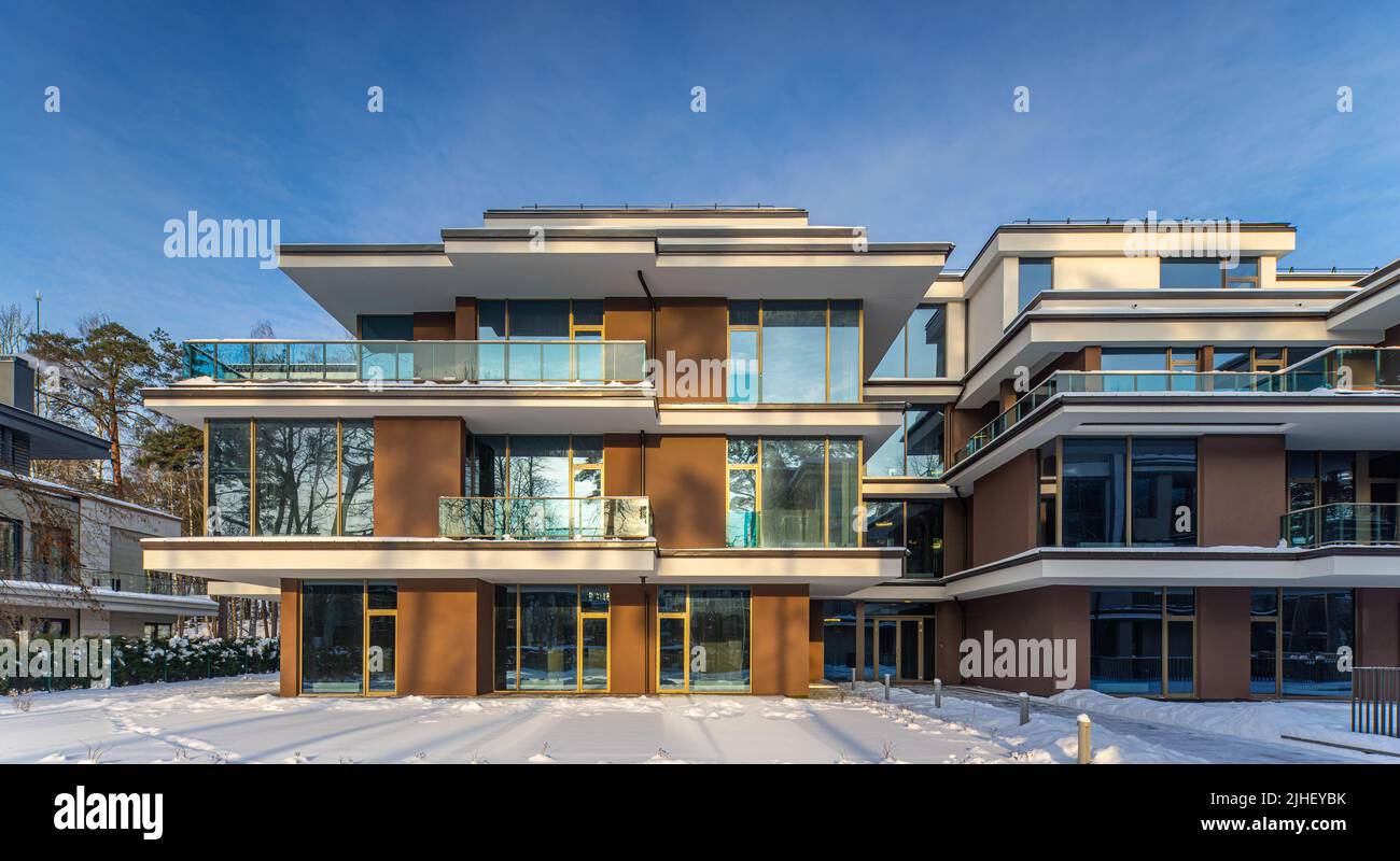 View of Modern exterior of new luxury residential building at winter. Private ...