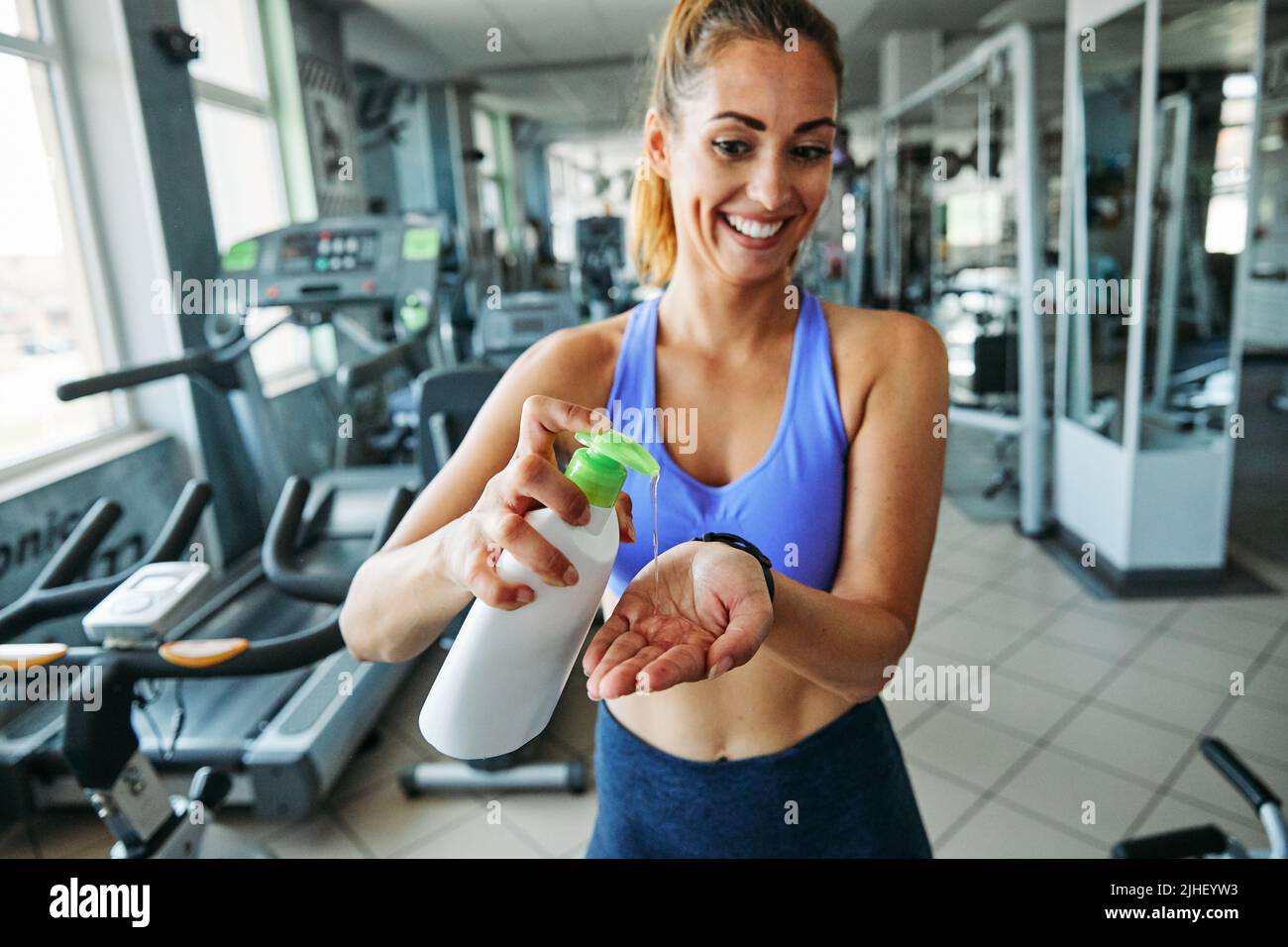 disinfection gym coronavirus hygiene protection cleaning safety epidemic virus woman soap hands Stock Photo