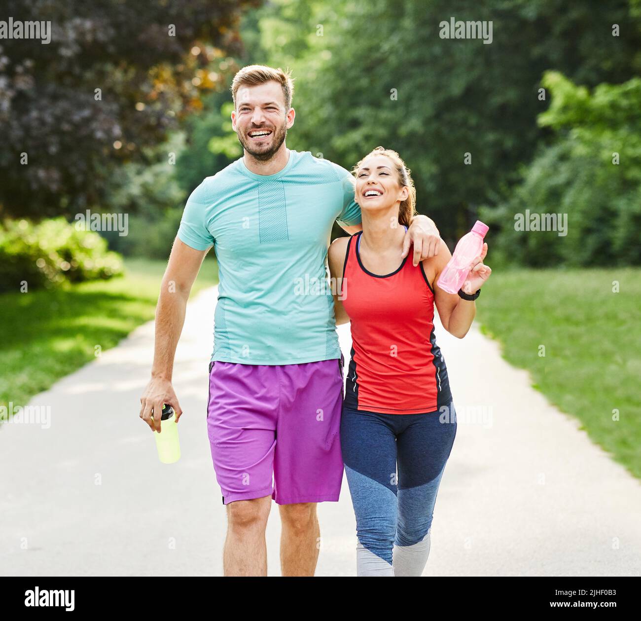 fitness woman park exercise lifestyle outdoor sport healthy couple nature active young fit training athlete Stock Photo