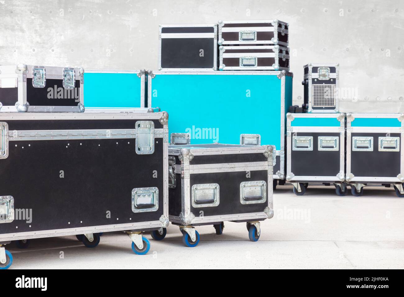 Group of black and blue flight cases on a concrete floor Stock Photo
