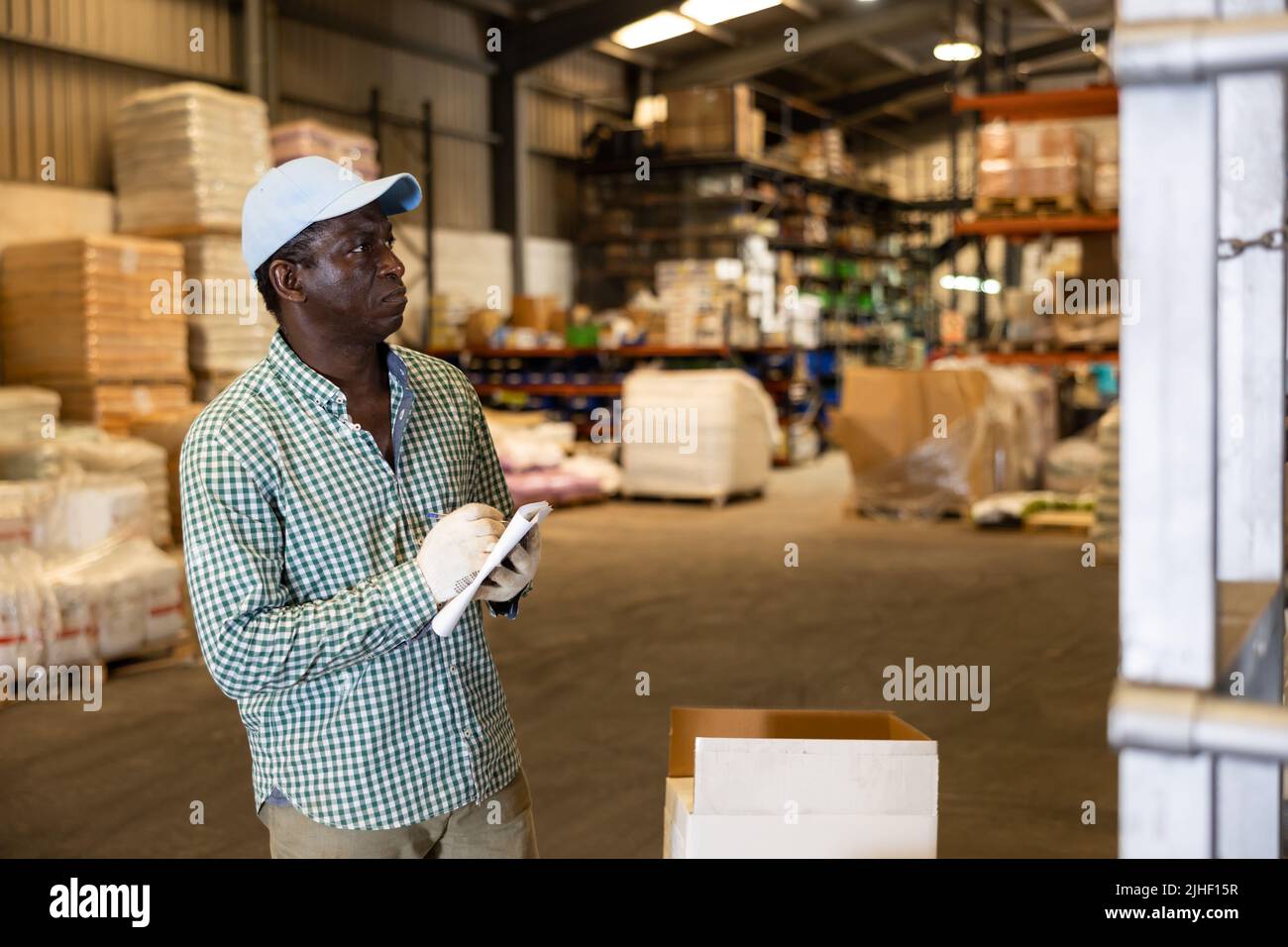 Portrait of focused African-American man checking order list Stock Photo