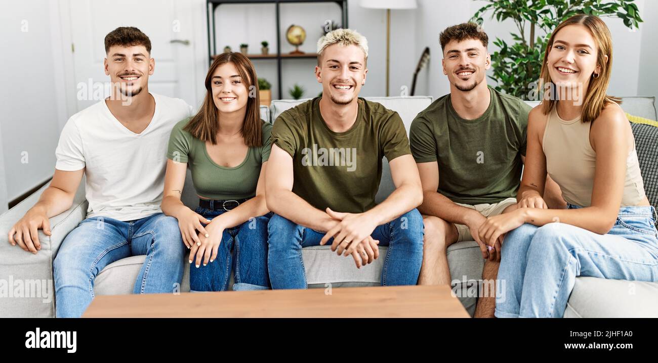 Group of young friends smiling happy sitting on the sofa at home Stock ...