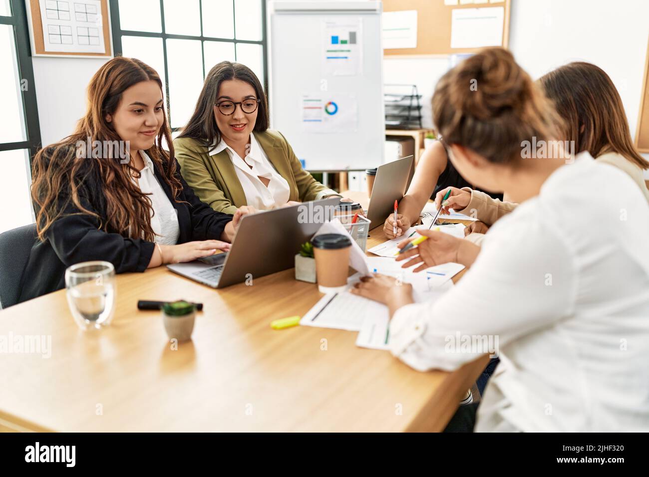 Group of young businesswomen smiling happy working at the office Stock ...