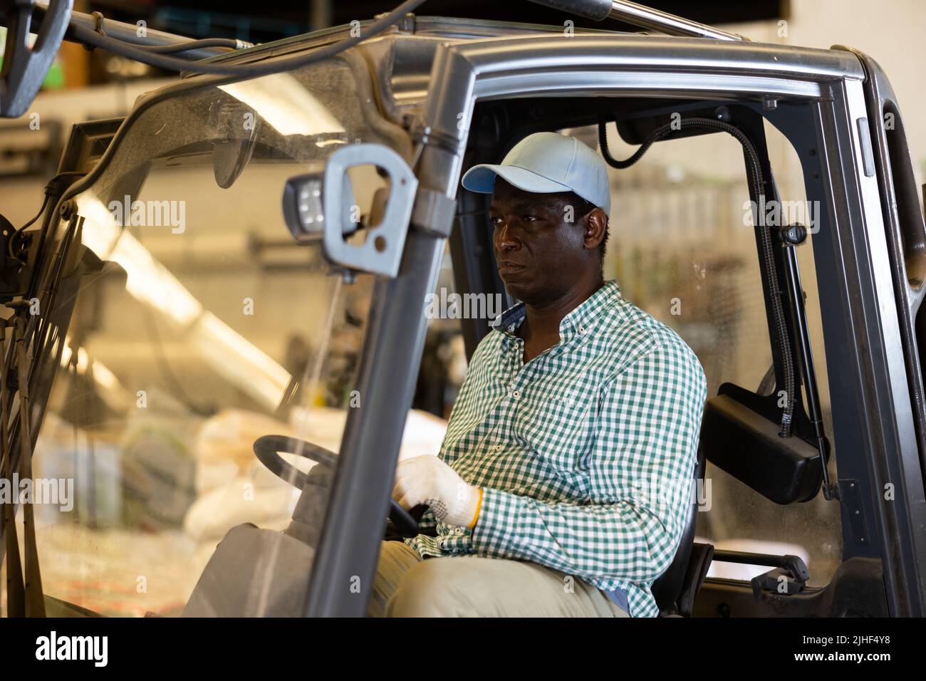 African American worker of warehouse working on forklift truck Stock ...
