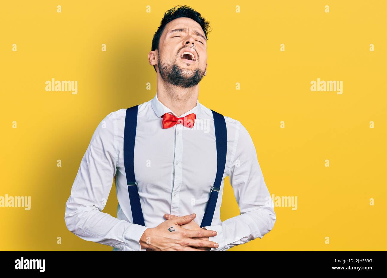 Hispanic man with beard wearing hipster look with bow tie and