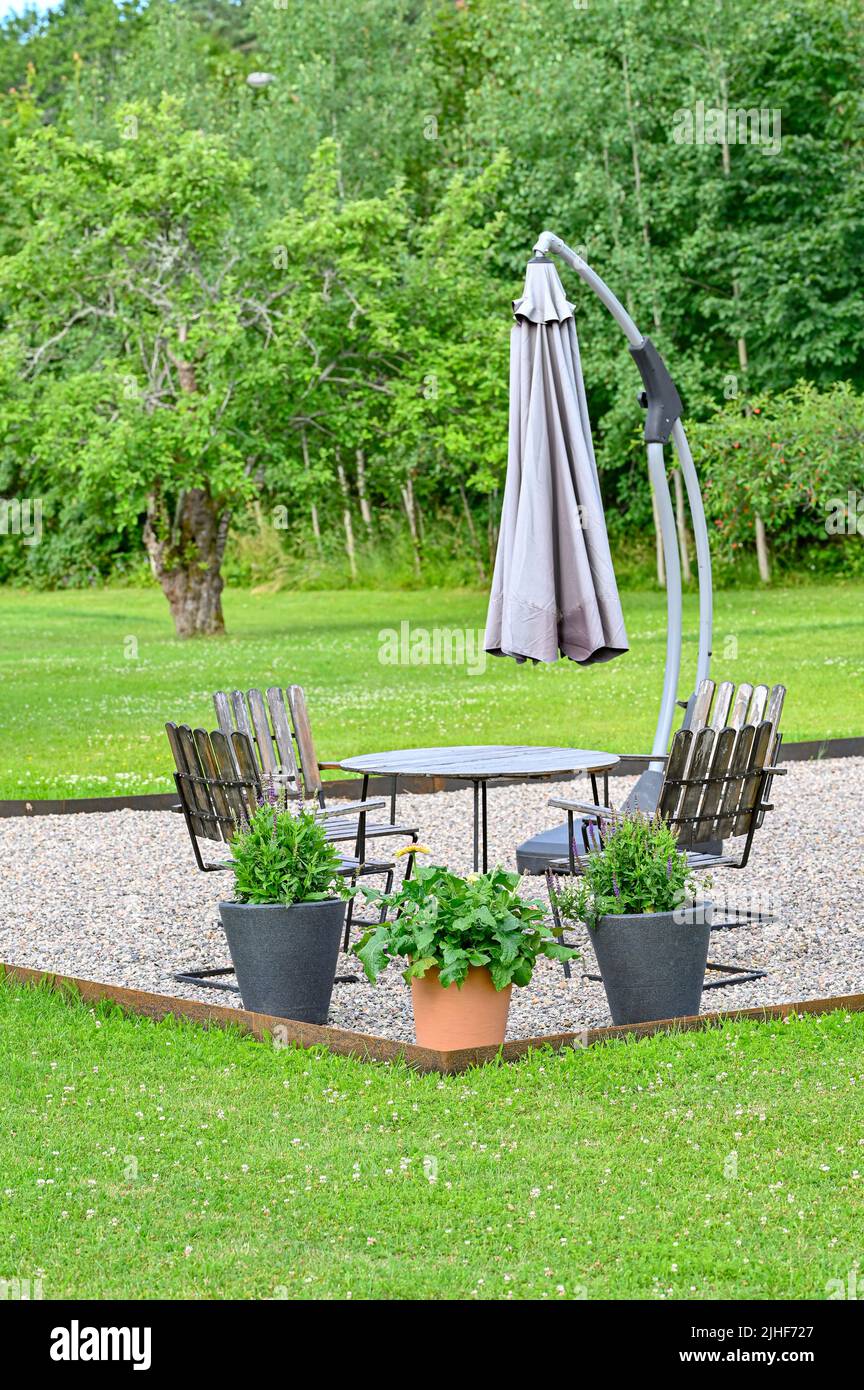 seating area and parasol in garden Kumla Sweden Stock Photo