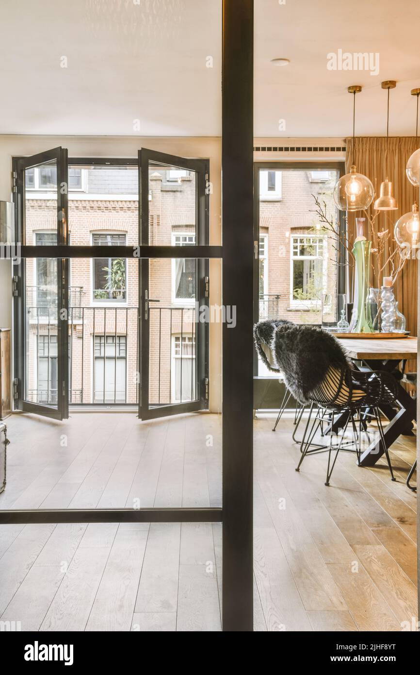 Interior of spacious light dining room and elegant chandelier located