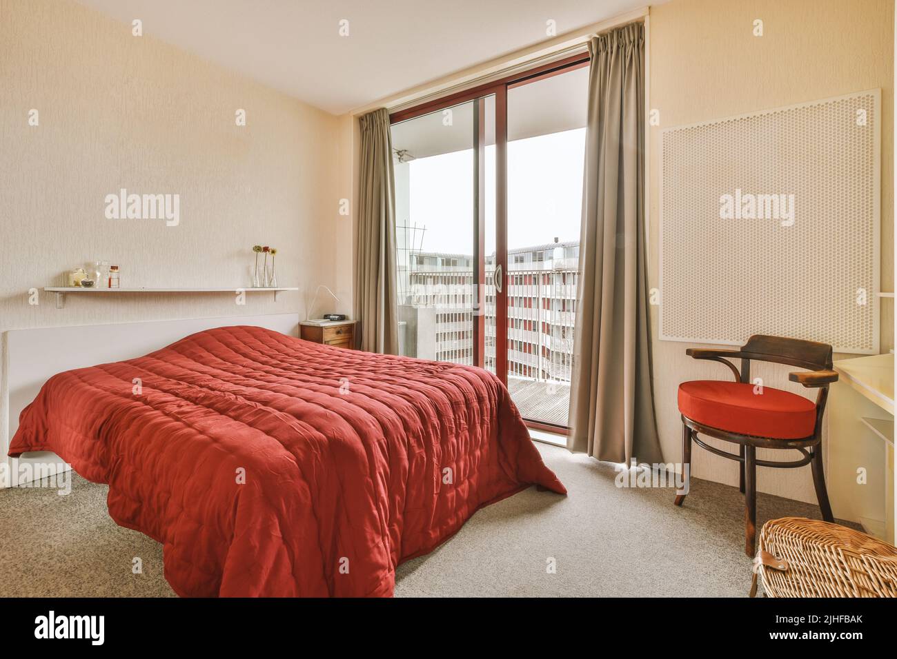 Comfortable bed with white bedclothes and bedside table with lamp