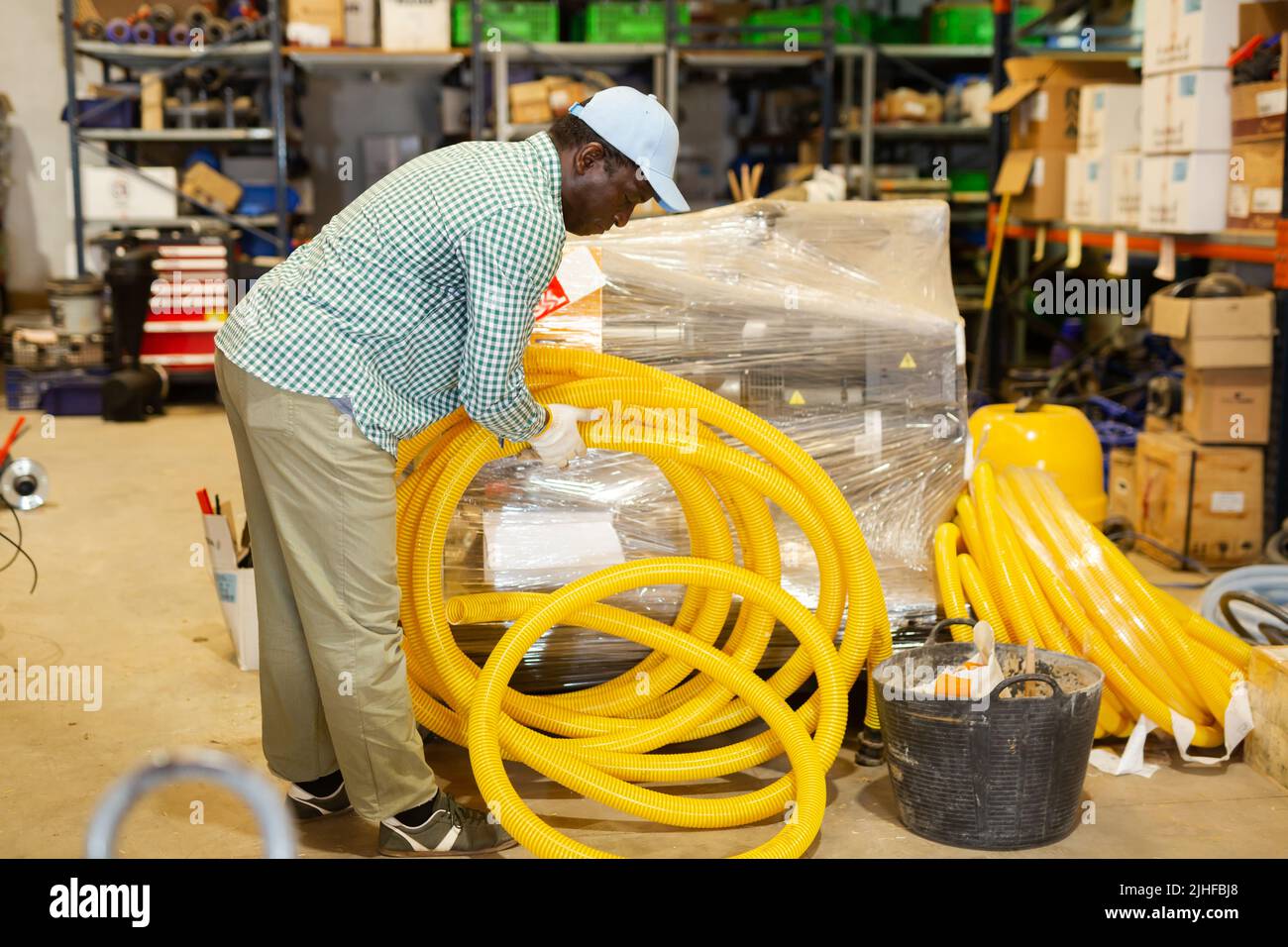 Portrait of focused African American man buying hoses Stock Photo
