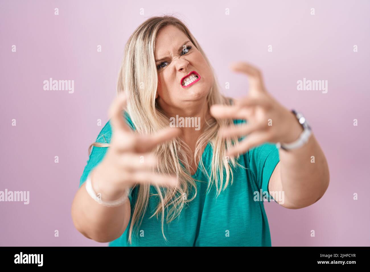 Caucasian Plus Size Woman Standing Over Pink Background Shouting Frustrated With Rage Hands 1283