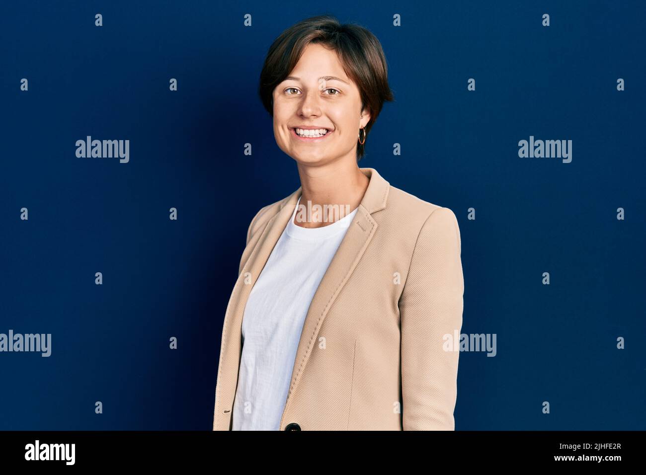 Young business woman smiling happy and confident standing over isolated ...