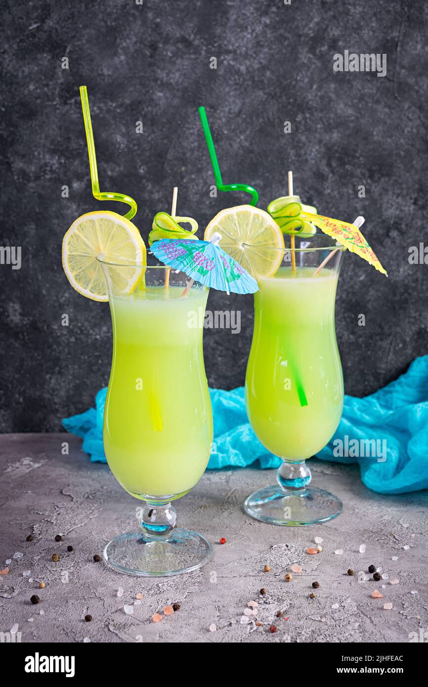 Glass of fresh cucumber juice. Cocktail with cucumber, ice and lemon