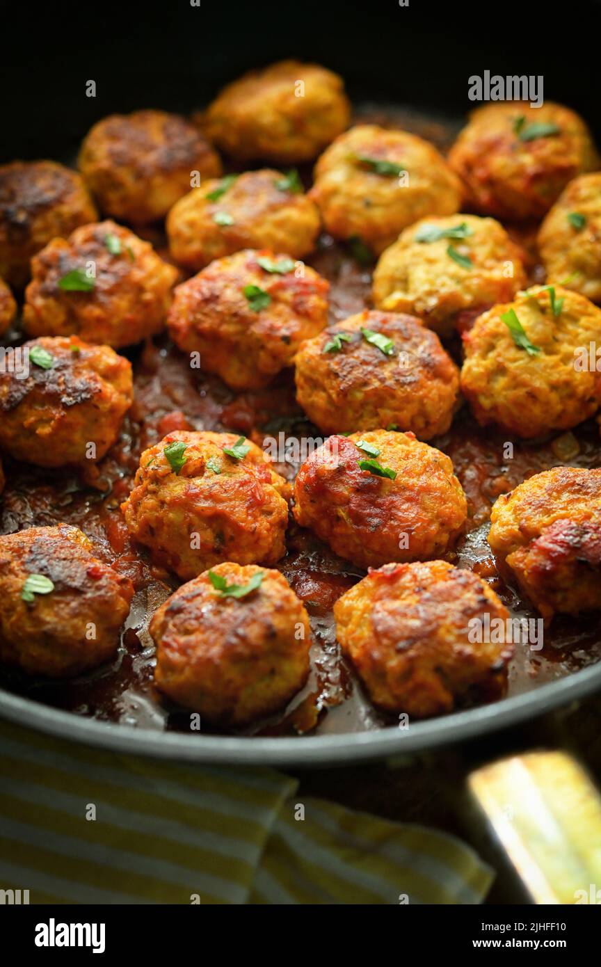 Closeup Meatballs and Tomato Sauce in Pan on table Stock Photo