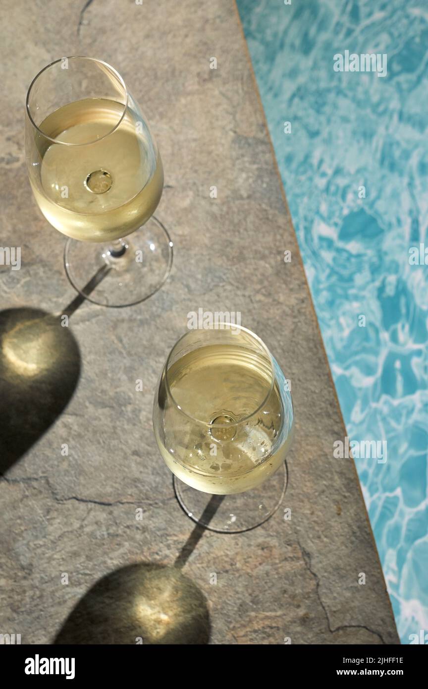Closeup Summer White Wine Glass near pool Stock Photo