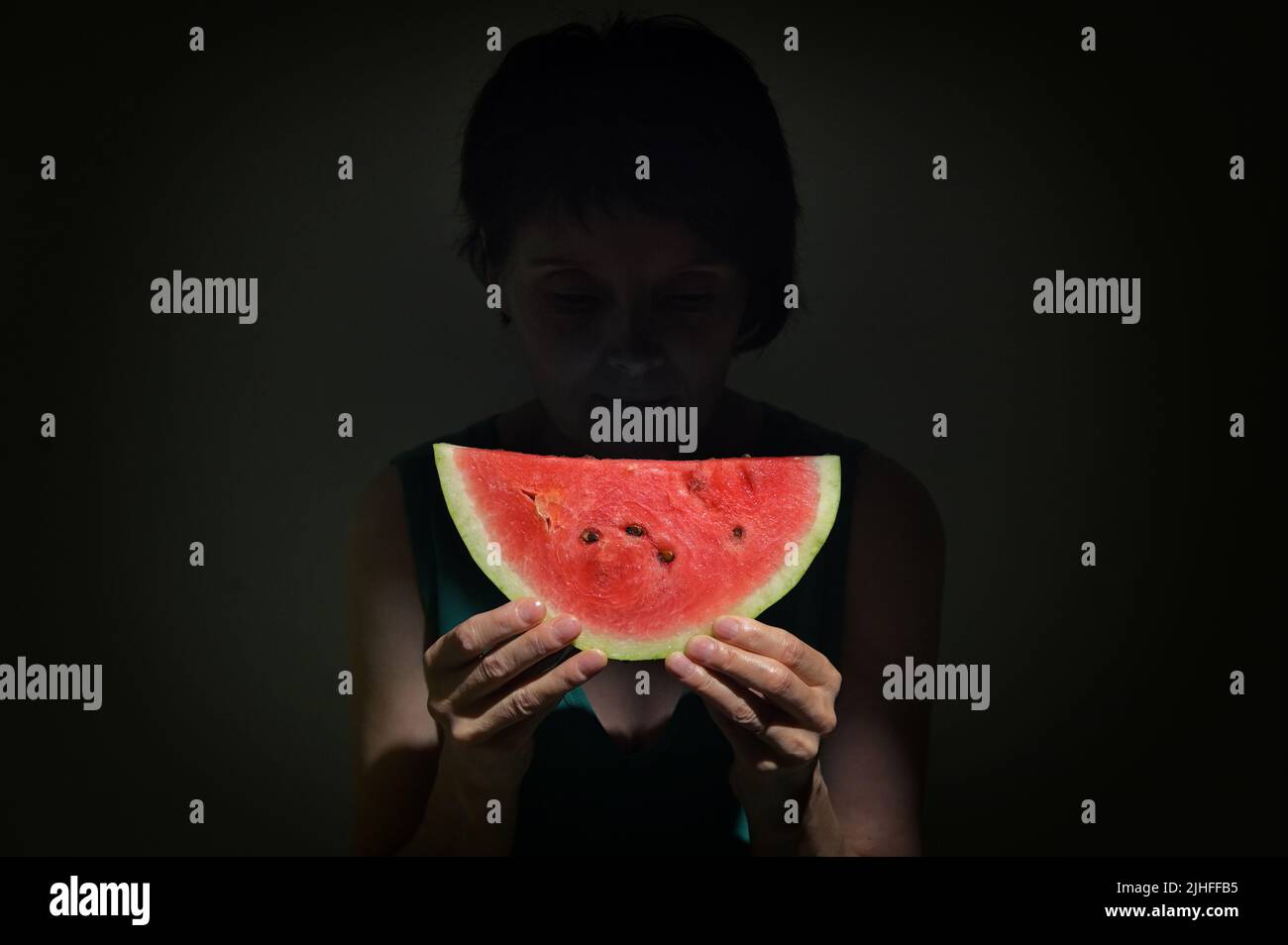 Woman Holding Slice Of A Red Watermelon in Studio Stock Photo