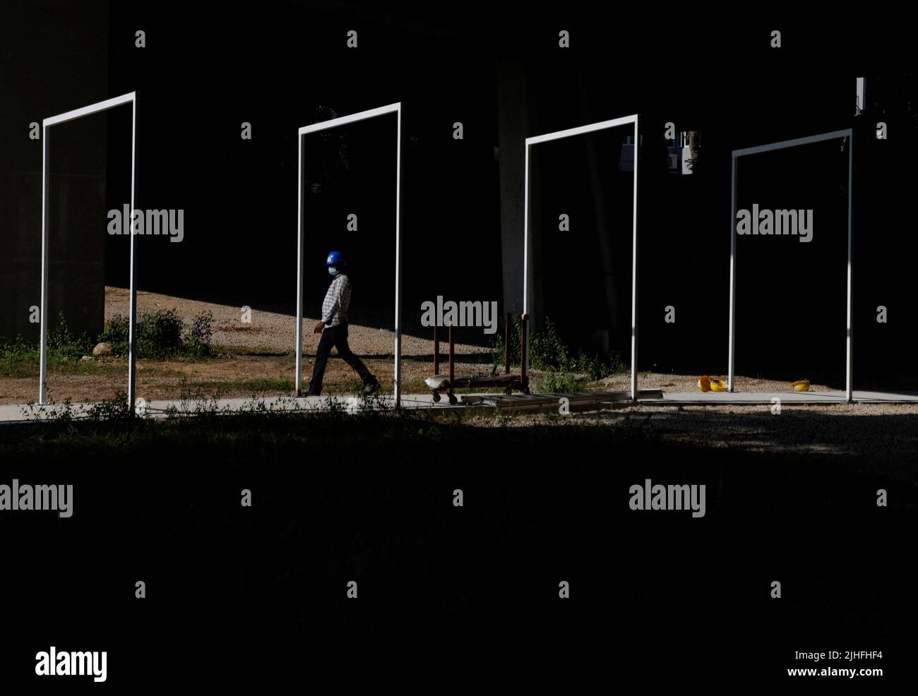 A migrant construction worker walks through a half-constructed pedestrian tunnel in Singapore July 18, 2022. REUTERS/Edgar Su Stock Photo