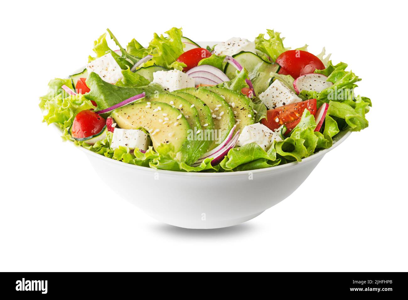 Healthy green salad with avocado feta cheese and fresh vegetables isolated on white Stock Photo
