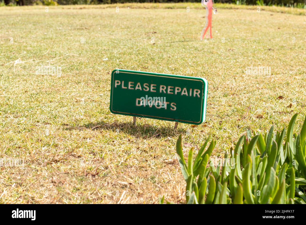 Repair divots sign at a golf course Stock Photo