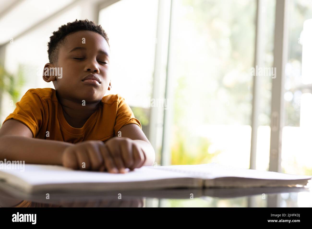 Image of smiling african american boy reading braille book Stock Photo
